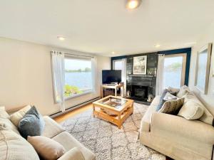 a living room with two couches and a fireplace at Salt Pond Sunrise View & 5 min to beach, sleeps 7 in Charlestown