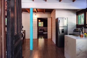 a kitchen with a stainless steel refrigerator and a counter at Miles Away in Cóbano
