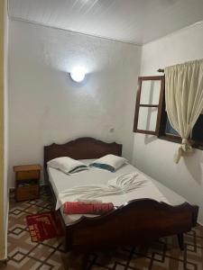 a bedroom with a bed in a room at Elitineide Guest House in São Tomé