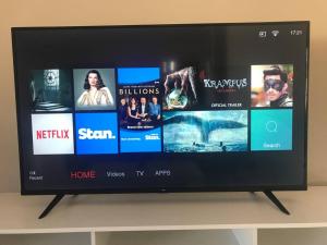 a flat screen tv sitting on top of a shelf at Tasha's Apartments in Angle Park - N38 in Woodville