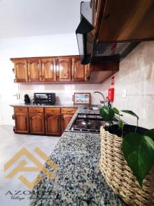 cocina con armarios de madera y encimera en Azores village apartments, en Fontinhas
