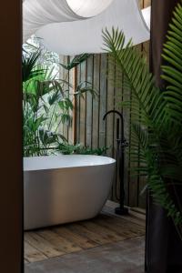 a bath tub in a bathroom with plants at Good Stand in Suao