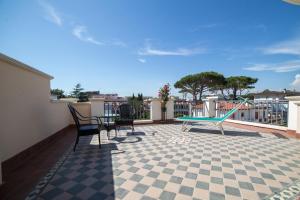 a patio with a ping pong table and chairs at Hotel Il Gabbiano in Sabaudia