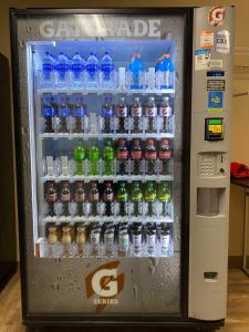 a vending machine filled with lots of water bottles at Suburban Studios Winston-Salem near Hanes Mall in Winston-Salem
