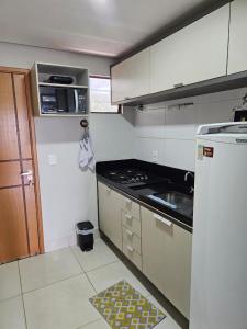 a kitchen with a refrigerator and a stove top oven at Alto Da Serra Villas in Bananeiras