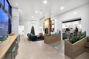 a lobby with potted plants and a christmas tree at Summit Lofts Boutique Hotel in Mount Shasta