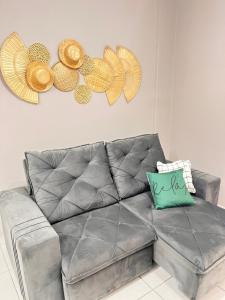 a living room with a gray couch with a pillow at Apartamento Av. atlântica lateral BrisamarBC6 in Balneário Camboriú