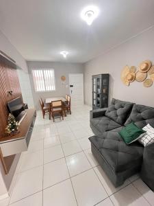 a living room with a black couch and a table at Apartamento Av. atlântica lateral BrisamarBC6 in Balneário Camboriú