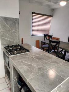 a kitchen with a stove and a counter top at Casa Lili in Cuernavaca