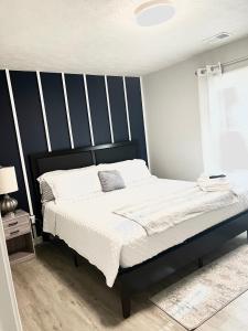a bedroom with a bed with a black and white headboard at Memorable and Enjoyable Near all the Action in Athens in Athens