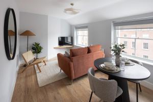 a living room with a couch and a table at Urban Rest Merrion Square Apartments in Dublin