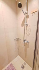 a bathroom with a shower with a bike in it at Azure 1BR with City and Nature View in Manila