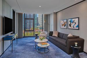 a living room with a couch and a tv at The St. Regis Chicago in Chicago