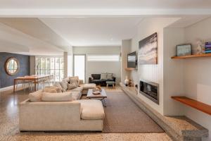 a living room with a couch and a fireplace at The Urban Beach House in Dunsborough