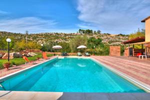 a swimming pool with a mountain in the background at Holiday Home Floridia - ISI02100b-O in Floridia