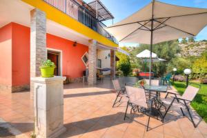 a patio with a table and an umbrella at Holiday Home Floridia - ISI02100b-O in Floridia