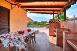 a patio with a table with bowls on it at Holiday Home Floridia - ISI02100b-O in Floridia