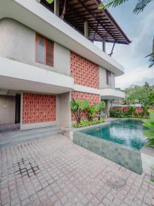 a house with a swimming pool in front of it at Tarate Loft Studio Ubud in Ubud
