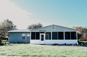 a small blue house with a garage at Hadley's House - A Country 3 Bdrm with Screened-In Porch in New Braunfels