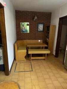 a room with two benches and a brick wall at CASA ELENA in Mar del Plata +1 photo