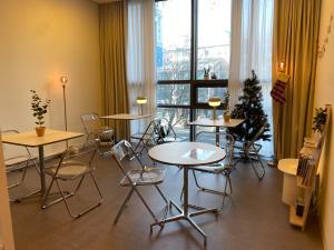 a room with tables and chairs and a christmas tree at Stay Seoul N Myeongdong in Seoul