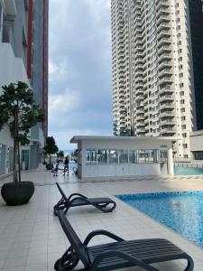 a view of a building with a pool and buildings at RC Firdaus Homestay Kuala Lumpur in Kuala Lumpur