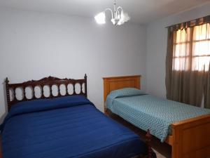 a bedroom with two beds and a window at Casa La Puntilla in Malargüe