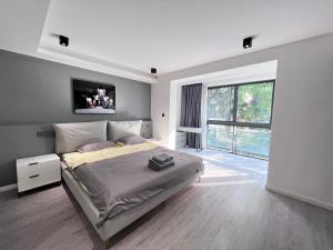 a bedroom with a bed with a television on the wall at Shanghai World Expo Villa B&B - Near Lujiazui in Shanghai
