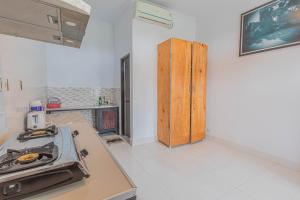 a kitchen with a stove and a counter top at Sekar Bali Homestay in Gianyar