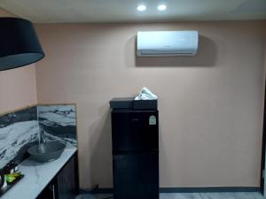 a room with a sink and a air conditioner on a wall at On & Off Hotel Bupyeong in Incheon