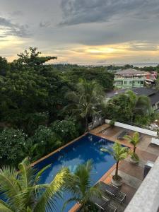 vista sul tetto di una piscina con palme di 2 Bedroom Seaview Lanta Sport Resort 303 a Phra Ae beach