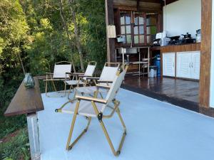 a group of chairs sitting on top of a patio at บ้านเล็กในป่าใหญ่ at น่าน Little House In the Forest at Nan 