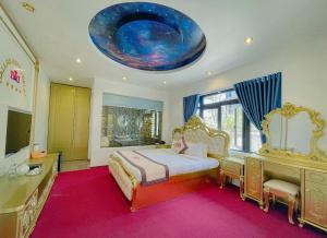 a large bedroom with a bed and a large ceiling at Dallas Hotel Dalat in Da Lat