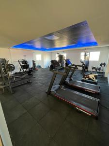 a gym with several tread machines in a room at Studio Estilo Industrial +Espaço in Mossoró