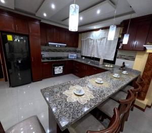 a kitchen with a table with chairs and a counter top at Your Home Away From Home ! in Ambato