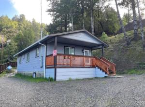 a small house with a porch and a deck at New, Fun-Size Benbow House! in Garberville