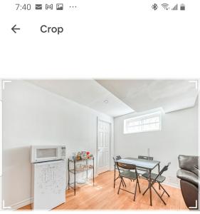 a living room with a table and a kitchen at Leila's Place-Family Deluxe Basement Apartment in Gatineau