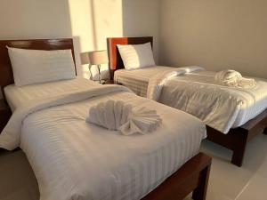 a room with two beds with white sheets at 2 Bedroom Seaview Apartment Lanta Sport Resort 305 in Phra Ae beach +15 photos