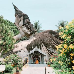 a statue of a large head in front of a building at Vientiane Garden Villa Hotel And Restaurant in Vientiane