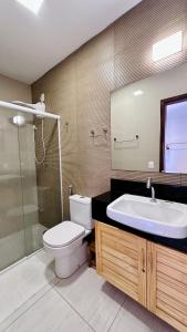 a bathroom with a toilet and a sink and a shower at Apê Jardins in Flecheiras +37 photos