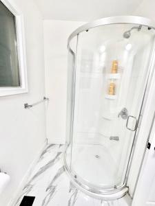 um chuveiro com uma porta de vidro na casa de banho em Bedroom 1 with free Parking, free wi-fi and shared washroom (Room 1) em Kitchener