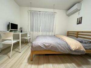 Postel nebo postele na pokoji v ubytování ティエラ北池袋
