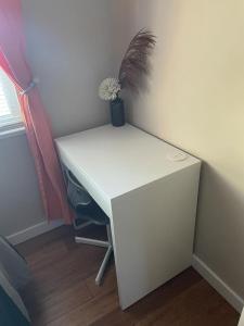 a white desk with a potted plant on top of it at Quaint Guest Room Close to Siesta Key in Sarasota
