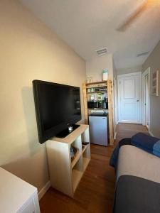 a living room with a flat screen tv on the wall at Quaint Guest Room Close to Siesta Key in Sarasota