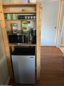 a kitchen with a counter with a microwave and a refrigerator at Quaint Guest Room Close to Siesta Key in Sarasota