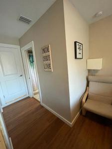 a living room with a chair and a door at Quaint Guest Room Close to Siesta Key in Sarasota