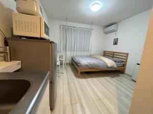 Postel nebo postele na pokoji v ubytování ティエラ北池袋