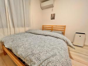 Postel nebo postele na pokoji v ubytování ティエラ北池袋