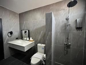 La salle de bains est pourvue de toilettes, d'un lavabo et d'une douche. dans l'établissement BB hotel Savannakhet, à Savannakhet