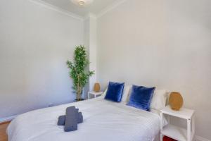a bedroom with a white bed with blue pillows at 3 Bedroom House Chippendale Near the Center 2 E-Bikes Included in Sydney